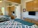 Main bedroom features a mirrored closet, a comfortable bed, and built-in TV at 7750 E Broadway Rd # 776, Mesa, AZ 85208