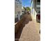 Gravel pathway alongside the home with a low rock wall at 7750 E Broadway Rd # 776, Mesa, AZ 85208