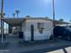 Single-wide manufactured home with covered carport and desert landscaping at 7807 E Main St # Cc-66, Mesa, AZ 85207