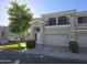 Two-story townhome with attached garage and landscaped front yard at 8180 E Shea Blvd # 1037, Scottsdale, AZ 85260