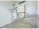 Unfinished garage area with water heater and storage cabinets at 8643 W Torreon Dr, Arizona City, AZ 85123