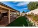 Artificial turf, covered patio, and a well-maintained desert landscape at 11552 E Dover St, Mesa, AZ 85207