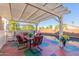 Covered patio with table and chairs overlooking the pool at 13418 W Stardust Blvd, Sun City West, AZ 85375