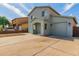 Two-story house with light teal siding, attached garage, and a long driveway at 1714 S 5Th St, Phoenix, AZ 85004