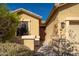 Front entry of the house with a brown door and sidelights at 18226 W Eva St, Waddell, AZ 85355