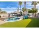 Relaxing kidney-shaped pool, lush grass, and patio furniture in backyard at 3114 E Wahalla Ln, Phoenix, AZ 85050