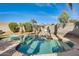 Refreshing kidney-shaped pool surrounded by a grassy backyard at 3114 E Wahalla Ln, Phoenix, AZ 85050