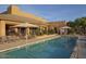 Community pool with lounge chairs, umbrellas, and a spa at 9240 E Broken Arrow Dr, Scottsdale, AZ 85262