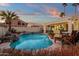 Large kidney shaped pool with a waterfall feature at 1015 E Mountain Sage Dr, Phoenix, AZ 85048