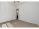 Bedroom with carpet, door to bathroom, and ceiling fan at 11122 E Tripoli Ave, Mesa, AZ 85212
