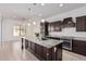 Modern kitchen with granite island and dark wood cabinets at 11122 E Tripoli Ave, Mesa, AZ 85212