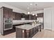 Modern kitchen with large island and dark wood cabinets at 11122 E Tripoli Ave, Mesa, AZ 85212