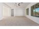 Spacious living room with large windows and ceiling fan at 11122 E Tripoli Ave, Mesa, AZ 85212