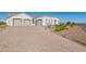 Front view of a modern home with a three-car garage and landscaped yard at 28538 N 203Rd Ave, Wittmann, AZ 85361