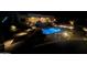 Illuminated pool and house at night, creating a relaxing backyard scene at 29523 N 146Th St, Scottsdale, AZ 85262