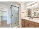 Modern bathroom with a glass shower, dual sinks, and a walk-in closet at 375 E Bracciano Ave, Queen Creek, AZ 85140