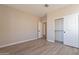 Simple bedroom with wood-look flooring and a large closet at 375 E Bracciano Ave, Queen Creek, AZ 85140