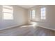 Bright bedroom with two windows, a window seat, and wood-look flooring at 375 E Bracciano Ave, Queen Creek, AZ 85140