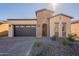 Single-story home with brick accents and a two-car garage at 375 E Bracciano Ave, Queen Creek, AZ 85140