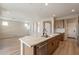 Open kitchen with island, stainless steel appliances, and hardwood floors at 375 E Bracciano Ave, Queen Creek, AZ 85140