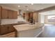 Modern kitchen with wood cabinets and stainless steel appliances at 375 E Bracciano Ave, Queen Creek, AZ 85140