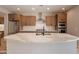 Modern kitchen with island, stainless steel appliances, and light wood cabinets at 375 E Bracciano Ave, Queen Creek, AZ 85140