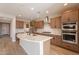 Modern kitchen with wood cabinets and stainless steel appliances at 375 E Bracciano Ave, Queen Creek, AZ 85140