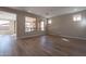 Bright living room with hardwood floors and sliding glass doors to backyard at 375 E Bracciano Ave, Queen Creek, AZ 85140