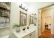 Clean bathroom with white vanity, mirror, and patterned towels at 401 W Locust Dr, Chandler, AZ 85248