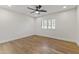 Well-lit bedroom with hardwood floors and ceiling fan at 5402 E Dahlia Dr, Scottsdale, AZ 85254