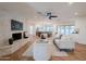 Open living room with stone fireplace and kitchen view at 5402 E Dahlia Dr, Scottsdale, AZ 85254