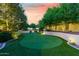 Backyard putting green with landscape lighting at 5791 S Columbus Ct, Gilbert, AZ 85298