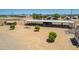 Aerial view of the property, showing the house, barns, and surrounding area at 6123 E Red Bird Ln, San Tan Valley, AZ 85140