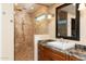 Bathroom with walk-in shower, vanity, and granite countertop at 8227 W Rose Garden Ln, Peoria, AZ 85382