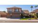 Two-story home with a three-car garage and landscaped front yard at 8227 W Rose Garden Ln, Peoria, AZ 85382