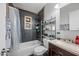 Bathroom with a bathtub/shower combo, dark tile, and white vanity at 1219 E Barcelona Ave, Casa Grande, AZ 85122