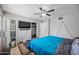 Bedroom with teal bedding, ceiling fan, attached bathroom, and ample closet space at 1219 E Barcelona Ave, Casa Grande, AZ 85122