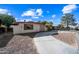 Front view of a single-story home with a curved driveway and desert landscaping at 1219 E Barcelona Ave, Casa Grande, AZ 85122