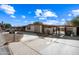 Street view of a single-story home with a driveway, landscaping, and a gated entryway at 1219 E Barcelona Ave, Casa Grande, AZ 85122