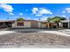 Front exterior view of a house with a circular driveway and gravel landscaping at 1219 E Barcelona Ave, Casa Grande, AZ 85122