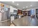 Kitchen features stainless steel appliances, ample counter space, white cabinets, and open shelving at 1219 E Barcelona Ave, Casa Grande, AZ 85122