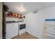 Laundry room with washer, dryer, and storage shelf at 1219 E Barcelona Ave, Casa Grande, AZ 85122