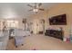 Living room with gray couches, large TV, and view into kitchen at 16872 W Taylor St, Goodyear, AZ 85338