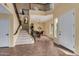 Two-story entryway with a staircase and tiled floors at 2724 S Falling Star Rd, Gold Canyon, AZ 85118