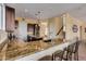 Kitchen breakfast bar with granite countertops and seating at 2724 S Falling Star Rd, Gold Canyon, AZ 85118