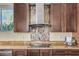 Close-up of kitchen cooktop and tile backsplash at 2724 S Falling Star Rd, Gold Canyon, AZ 85118