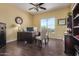 Home office with built-in desk, large window, and hardwood floors at 2724 S Falling Star Rd, Gold Canyon, AZ 85118