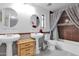 Bathroom with double sinks, a bathtub, and a shower at 3401 N Dakota St, Chandler, AZ 85225