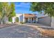 White stucco house with gray garage door, landscaping, and a paved driveway at 3401 N Dakota St, Chandler, AZ 85225
