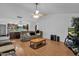 Spacious living room with hardwood floors, a large TV, and access to the kitchen at 3401 N Dakota St, Chandler, AZ 85225
